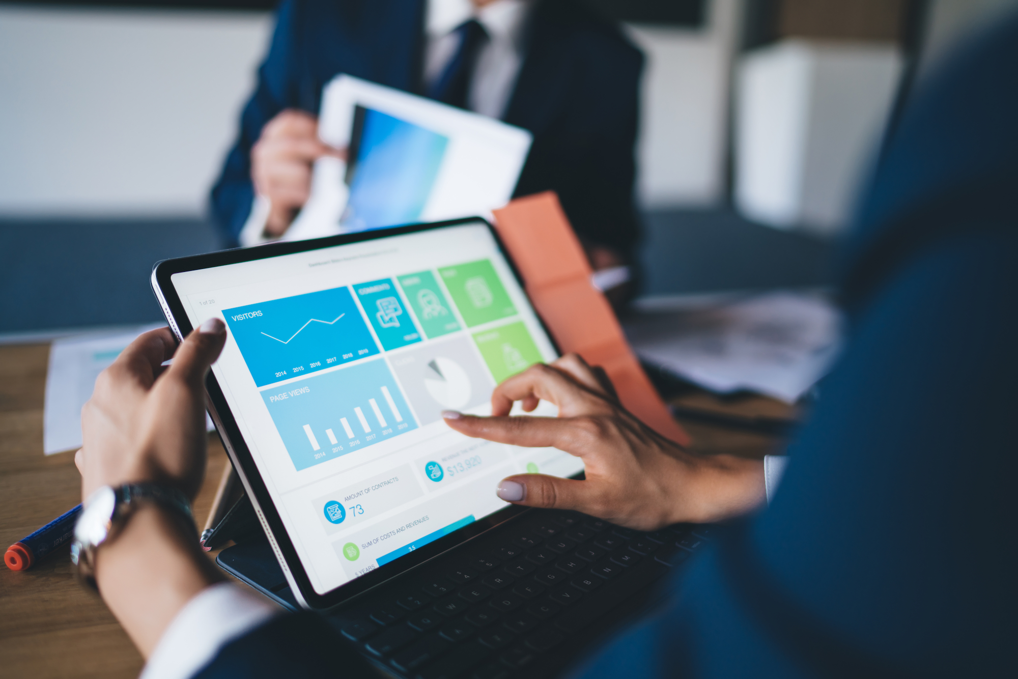 Woman using tablet, looking at statistics